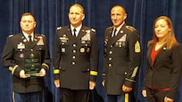 From left, Commander 367th Engineer Battalion, Lt. Col. Jerry Criswell; Commanding General U.S. Army Forces Command, Gen. Robert Abrams; Command Sergeant Major 367th Engineer Battalion, Command Sgt. Maj. Eric Larson; and Supervisory Staff Administrator 367th Engineer Battalion, Mrs. Holly Nygaard, pose with the 367th Engineer Battalion’s newly awarded Walter T Kerwin Readiness Award during the breakfast presentation. The 367th received the award from the Association of the United States Army (AUSA) for their accomplishments in 2015 during AUSA’s annual meeting and exhibition, October 3, 2016. (U.S. Army photo by Chief Warrant Officer 5 Therese Beatty/Released)