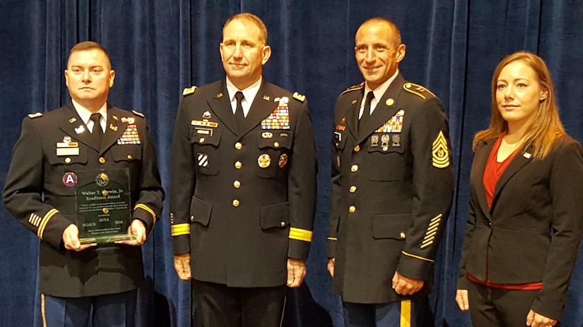 From left, Commander 367th Engineer Battalion, Lt. Col. Jerry Criswell; Commanding General U.S. Army Forces Command, Gen. Robert Abrams; Command Sergeant Major 367th Engineer Battalion, Command Sgt. Maj. Eric Larson; and Supervisory Staff Administrator 367th Engineer Battalion, Mrs. Holly Nygaard, pose with the 367th Engineer Battalion’s newly awarded Walter T Kerwin Readiness Award during the breakfast presentation. The 367th received the award from the Association of the United States Army (AUSA) for their accomplishments in 2015 during AUSA’s annual meeting and exhibition, October 3, 2016. (U.S. Army photo by Chief Warrant Officer 5 Therese Beatty/Released)