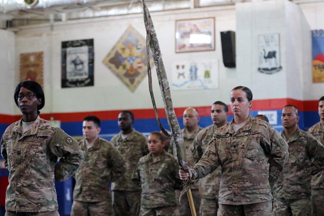 The Third Army Augmentation Company Commander, Capt. Doreen D. Fuller, left, and Guideon bearer, Spc. Ashleigh Palumbo, right, stand in formation with the cased colors during an inactivation ceremony for the U.S. Army Central unit at Camp Arifjan, Kuwait, September 28, 2016. The company has deployed 60 detachments of 50-plus Army Reserve Soldiers since Sept. 11, 2001 to the Central Command theater of operations. (U.S. Army photo by Sgt. Brandon Hubbard, USARCENT Public Affairs)