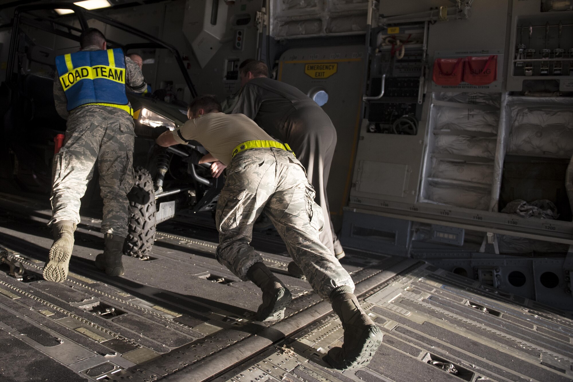 Loadmasters from the 6th Airlift Squadron and 305th Aerial Port Squadron secure an all-terrain vehicle on board a C-17 Globemaster III at Joint Base McGuire-Dix-Lakehurst, N.J., Oct. 3, 2016. The aircraft, with personnel and equipment from the 621st Contingency Response Wing, is bound for Haiti in response to Hurricane Matthew. The 621st Contingency Response Wing has units continuously on alert and ready to deploy anywhere in the world in support of emergency operations, such as hurricane relief, within 12 hours of notification.