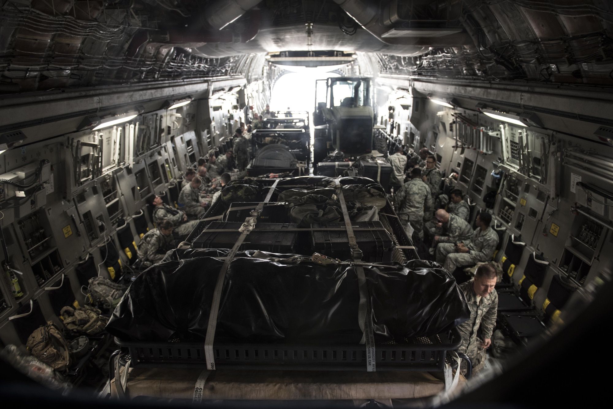 More than 30 members of the 621st Contingency Response Wing aboard a C-17 Globemaster III at Joint Base McGuire-Dix-Lakehurst, N.J. wait for equipment to be loaded on before takeoff on their way to Port-au-Prince, Haiti in response to Hurricane Matthew, October 6, 2016. The CRW is supporting the government of Haiti's request for humanitarian assistance. Once on the ground, the CRW will provide assistance by facilitating the movement of humanitarian aid and cargo.