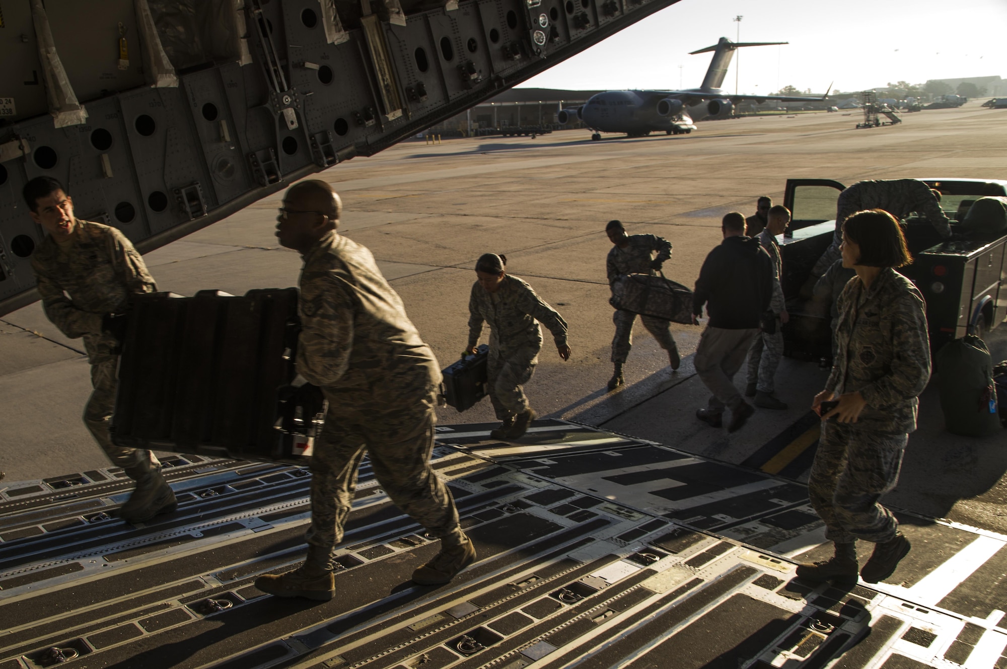 Members of the 621st Contingency Response Wing load equipment onto a C-17 Globemaster III at Joint Base McGuire-Dix-Lakehurst, N.J. before departing to support humanitarian relief efforts Port-au-Prince, Haiti, in response to Hurricane Matthew, October 6, 2016. Once on the ground, the CRW will provide assistance by facilitating the movement of humanitarian aid and cargo. (U.S. Air Force photo by Tech. Sgt. Gustavo Gonzalez/Released)