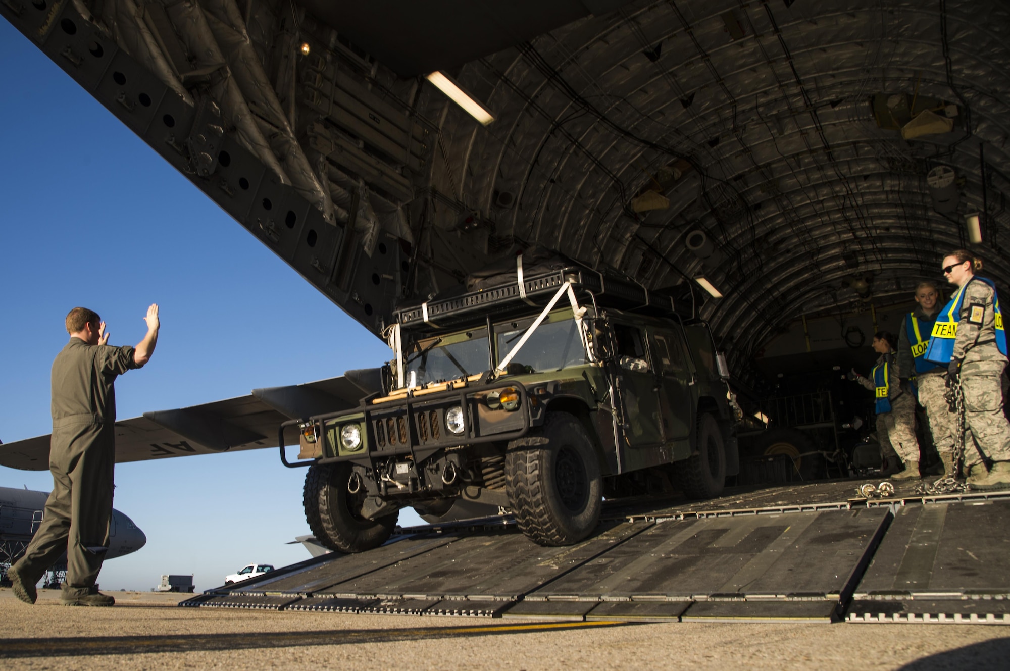 U.S. Air Force aerial porters assigned to the 305th Aerial Port Squadron load a Humvee onto a C-17 Globemaster III at Joint Base McGuire-Dix-Lakehurst, N.J., October 6, 2016. The Humvee, along with other equipment and more than 30 members of the 621st Contingency Response Wing will be on their way to Port-au-Prince, Haiti in response to Hurricane Matthew. The CRW is highly-specialized in rapidly deploying personnel to quickly open airfields and establish, expand, sustain, and coordinate air mobility operations alongside joint and intra-agency partners. (U.S. Air Force photo by Tech. Sgt. Gustavo Gonzalez/Released)
