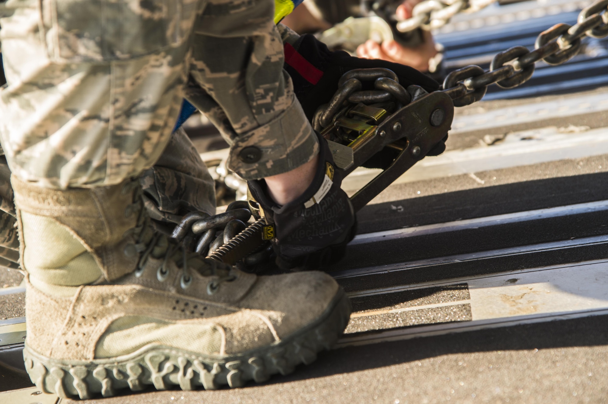 A U.S. Air Force aerial porter assigned to the 305th Aerial Port Squadron, chains down a Humvee onto C-17 Globemaster III at Joint Base McGuire-Dix-Lakehurst, N.J., October 6, 2016. The Humvee, along with other equipment and more than 30 members of the 621st Contingency Response Wing are headed to Port-au-Prince, Haiti, in response to Hurricane Matthew. Once on the ground, the CRW will provide assistance by facilitating the movement of humanitarian aid and cargo. (U.S. Air Force photo by Tech. Sgt. Gustavo Gonzalez/Released)