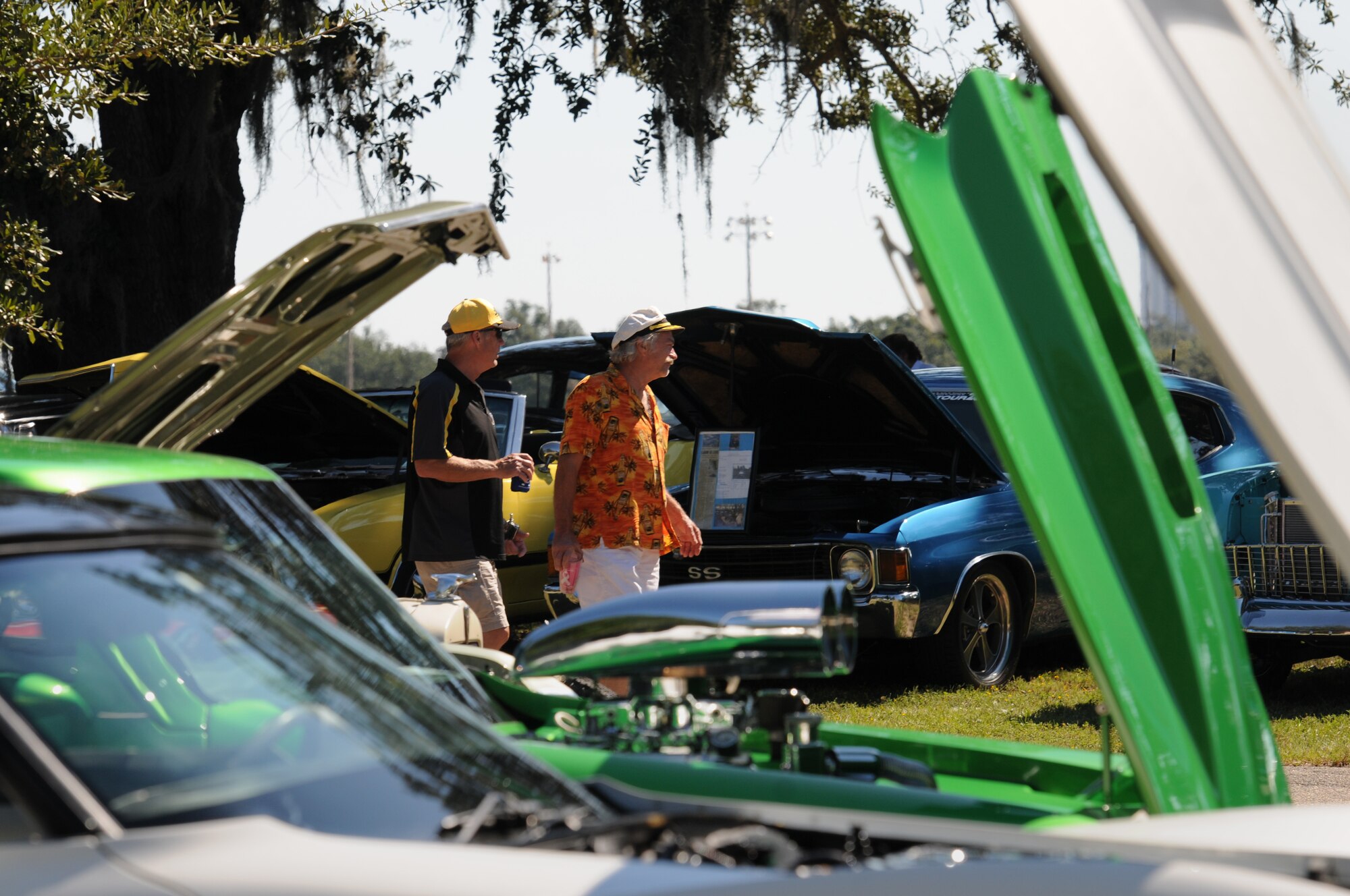 Larry Massingill and David Childress, Mississippi residents, walk through a display of antique vehicles at marina park during the Cruisin’ Keesler 13th Annual Car Show Oct. 1, 2016, on Keesler Air Force Base, Miss. There were over 130 classic car, truck, bike and hot rod entries with more than 40 awards presented. (U.S. Air Force photo by Kemberly Groue/Released)