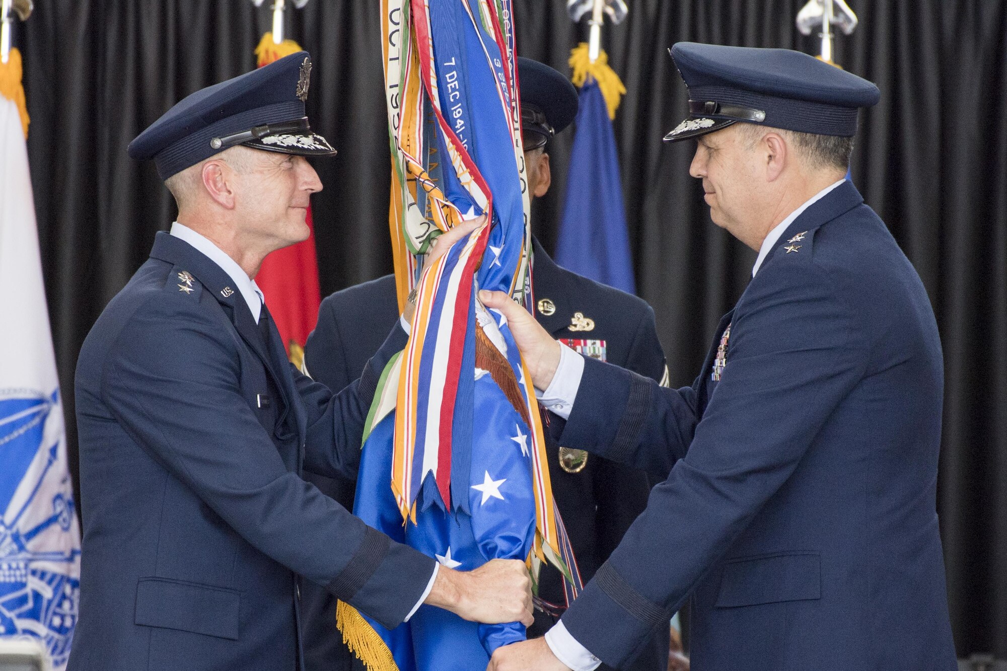 Gen. Terrence J. O’Shaughnessy, Pacific Air Force commander, passes the 5th Air Force guidon to the new USFJ and 5th AF commander, Lt. Gen. Jerry P. Martinez, during the USFJ and 5th AF assumption of command ceremony at Yokota Air Base, Japan, Oct. 6, 2016. Martinez was the former director of operations, Headquarters Air Mobility Command, Scott Air Force Base. (U.S. Air Force photo by Yasuo Osakabe/Released) 