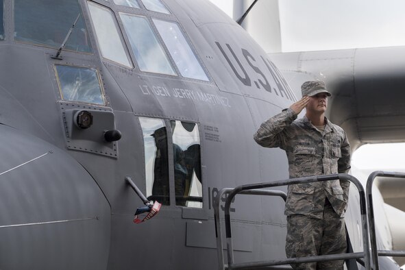 Staff Sgt. Kenneth Sutton, 374th Aircraft Maintenance Squadron crew chief, salutes the new United States Forces Japan and 5th Air Force commander, Lt. Gen. Jerry P. Martinez, after revealing the incoming commander’s name on the flagship C-130 Hercules during the USFJ and 5th AF assumption of command ceremony at Yokota Air Base, Japan, Oct. 6, 2016. (U.S. Air Force photo by Yasuo Osakabe/Released) 