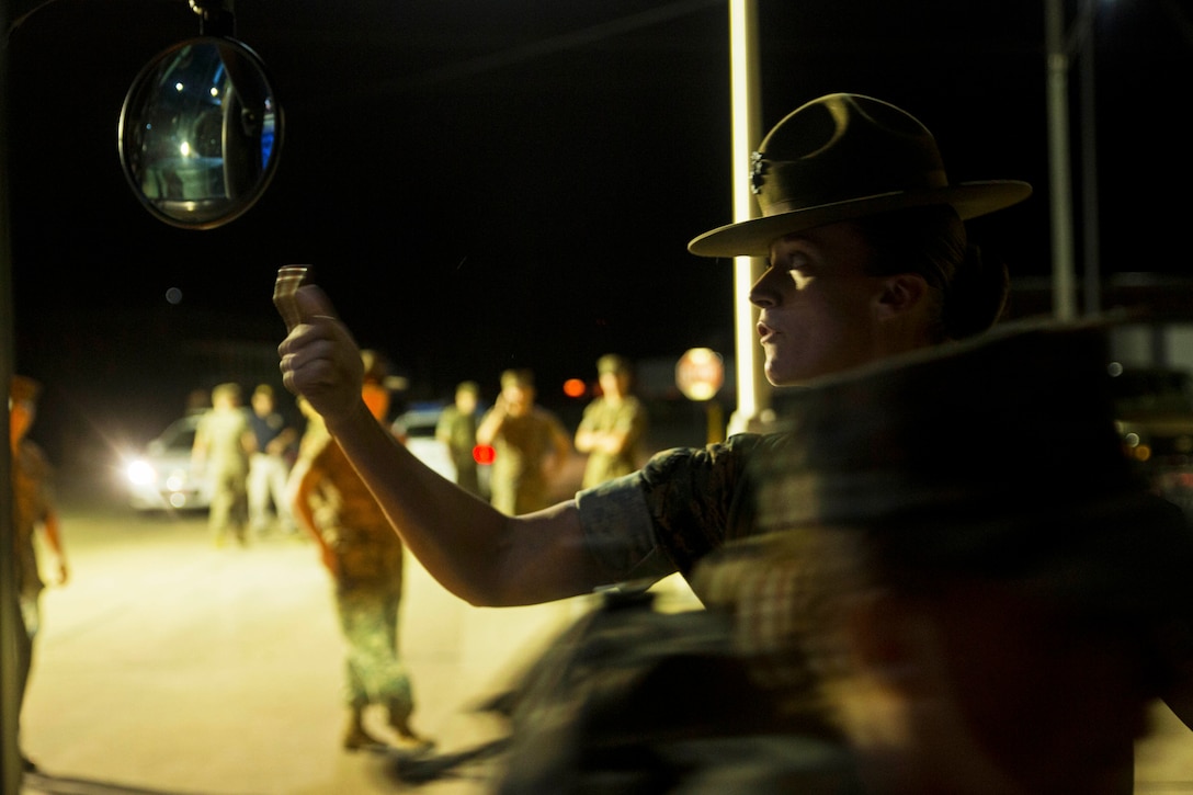 Marine Corps Staff Sgt. Kayla D. Caffero signals recruits to designated areas during evacuation ahead of Hurricane Matthew at Marine Corps Recruit Depot Parris Island, S.C., Oct. 5, 2016. Military units up and down the East Coast prepared to respond to the hurricane's impact and provide disaster relief support. Marine Corps photo by Lance Cpl. Aaron Bolser