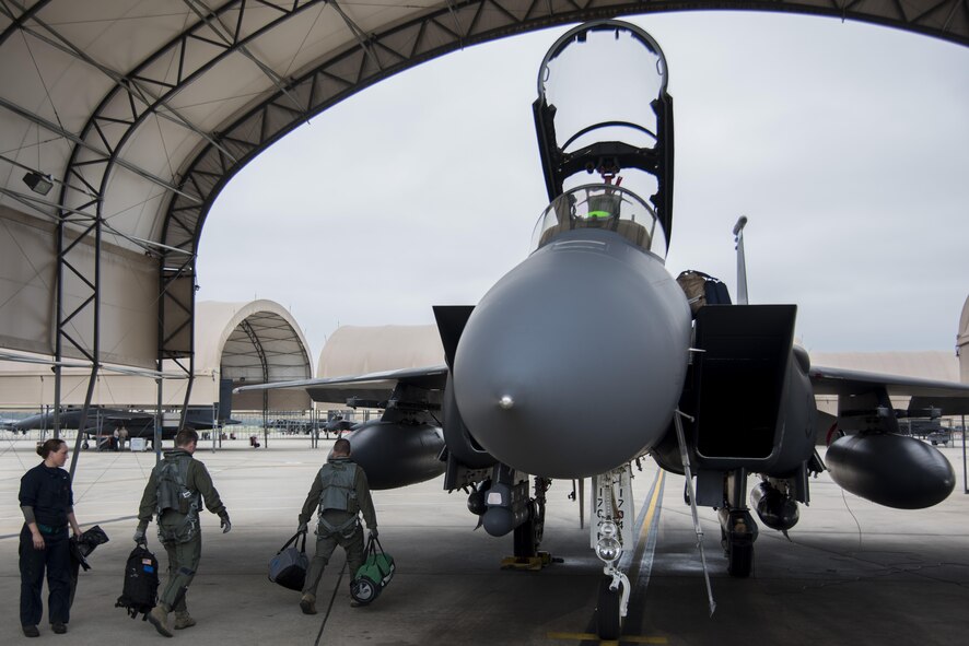 Aircrew members load their bags onto a F-15E Strike Eagle prior to departing as a precautionary measure to avoid severe weather associated with Hurricane Matthew, Oct. 6, 2016, at Seymour Johnson Air Force Base, North Carolina. More than 40 F-15E Strike Eagles and six KC-135R Stratotanker aircraft were repositioned to Barksdale Air Force Base, Louisiana. (U.S. Air Force photo by Senior Airman Brittain Crolley)