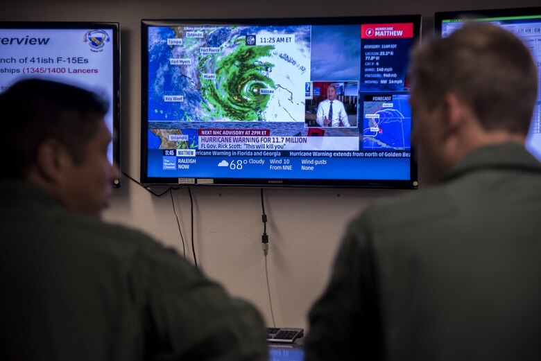 Aircrew members from the 334th Fighter Squadron watch the latest weather updates prior to evacuating as a precautionary measure due to Hurricane Matthew, Oct. 6, 2016, at Seymour Johnson Air Force Base, North Carolina. More than 40 F-15E Strike Eagles and six KC-135R Stratotanker aircraft were repositioned to Barksdale Air Force Base, Louisiana to avoid potential damage from severe weather associated with Matthew. (U.S. Air Force photo by Senior Airman Brittain Crolley)