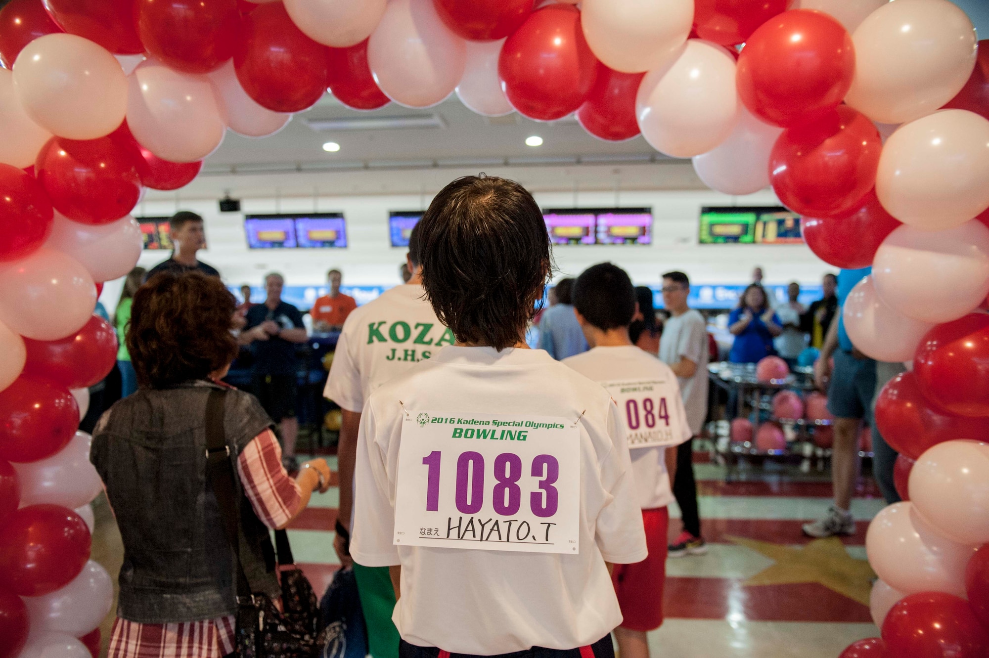 Sports participant, Hayato, receives a greeting from Team Kadena event volunteers during the 12th annual Kadena Special Olympics bowling competition Oct. 1, 2016, at Enagic Bowl, Okinawa, Japan. The bowling competition is one of three key events during the KSO. The other two events feature an art exhibit and game day featuring various sporting competitions. (U.S. Air Force photo by Senior Airman Peter Reft)