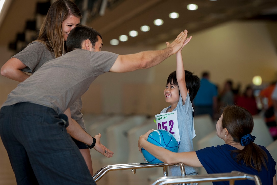 U.S. Air Force Capt. Ryan Witzig, event volunteer assigned to Kadena Air Base, Japan, high-fives Misono, sports participant, during the 12th annual Kadena Special Olympics bowling competition Oct. 1, 2016, at Enagic Bowl, Okinawa, Japan. The bowling event is part of a multi-day KSO for special needs family members of both U.S. service members and Okinawans. (U.S. Air Force photo by Senior Airman Peter Reft)