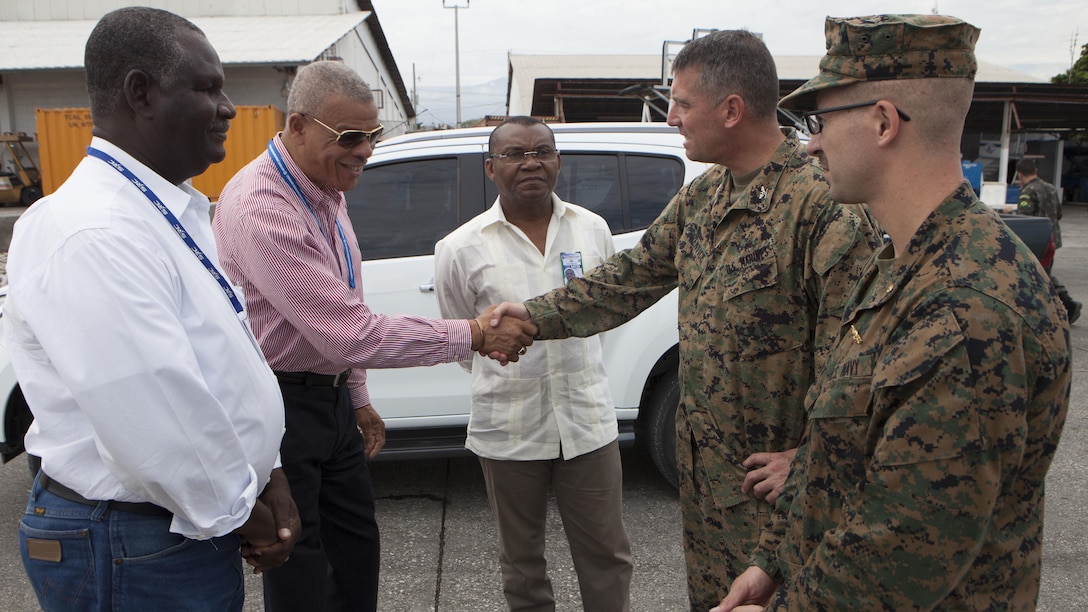 U.S. Marine Corps Col. Thomas Prentice, commanding officer of Special Purpose Marine Air-Ground Task Force Southern Command, right, shakes hands with Harry Clinton, general director of Toussaint Louverture International Airport, left, as they discuss possible staging areas for helicopters that will be used during relief operations for areas affected by Hurricane Matthew, at Port-au-Prince, Haiti, Oct. 6, 2016. Marine Corps photo by Sgt. Adwin Esters