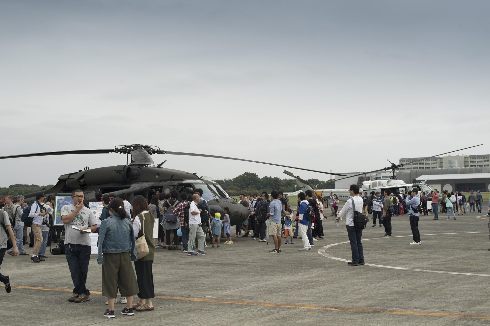 A U.S. Army UH-60 Blackhawk and a U.S. Air Force UH-1N Iroquois are displayed during the 43rd anniversary event of Japan Ground Self-Defense Force Camp Tachikawa at JGSDF Camp Tachikawa, Japan, Oct. 1, 2016. Service members with the 459th Airlift Squadron, Yokota Air Base and Army Aviation Battalion, Camp Zama, participated in the festival. The festival displayed helicopters assigned to the JGSDF, Japan Maritime Self-Defense Force, Metropolitan Police Department, Tokyo Fire Department and Japanese Red Cross. (U.S. Air Force photo by Yasuo Osakabe/Released) 