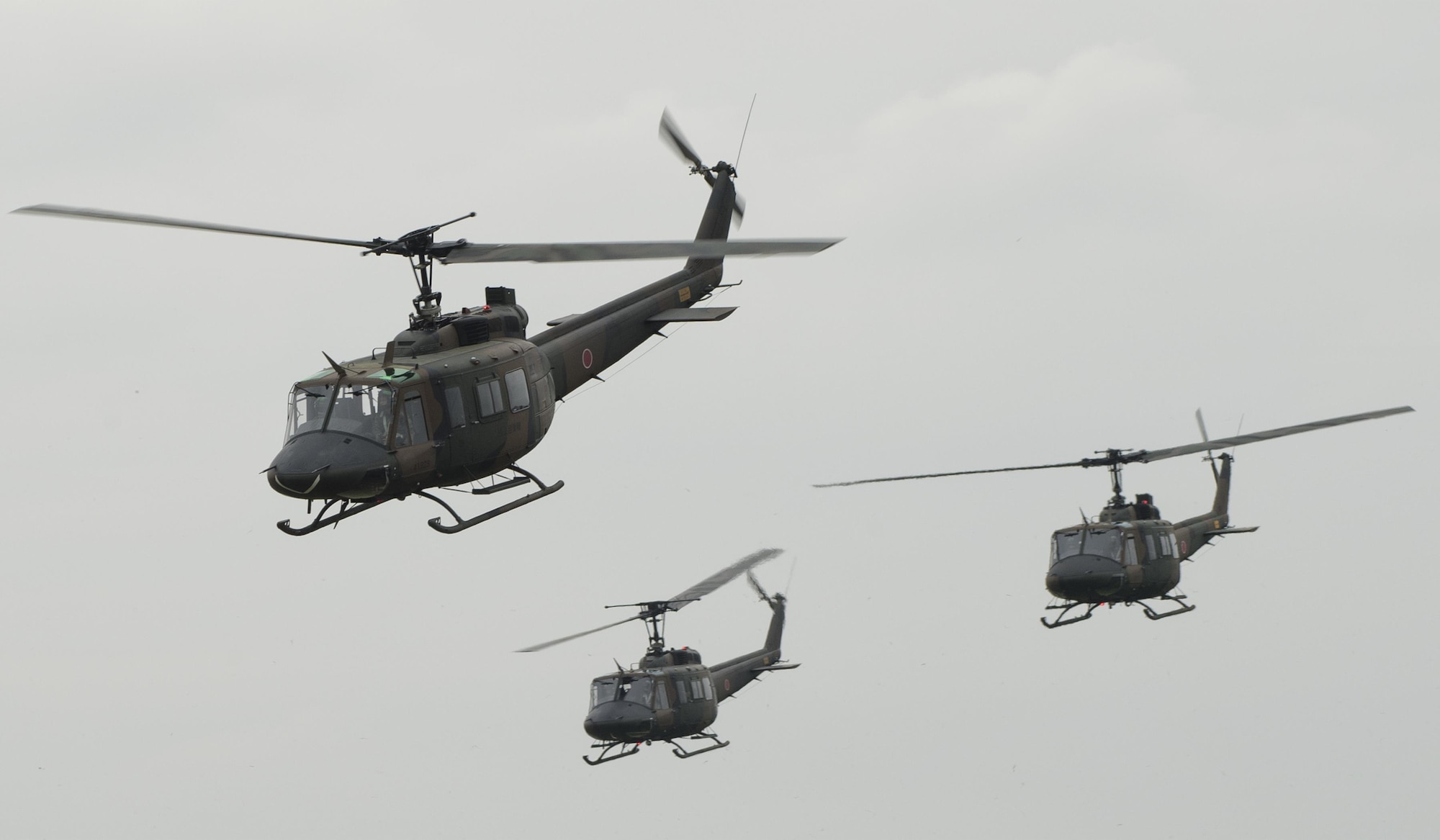 Japan Ground Self-Defense Force UH-1Js fly in formation during the 43rd Anniversary Event of Japan Ground Self-Defense Force Camp Tachikawa at JGSDF Camp Tachikawa, Japan, Oct. 1, 2016. JGSDF UH-1Js assigned to Eastern Army Helicopter demonstrated flight formations, hoist techniques and disaster relief procedures with first responders. Service members with the 459th Airlift Squadron from Yokota Air Base and Army Aviation Battalion from Camp Zama participated in the festival. (U.S. Air Force photo by Yasuo Osakabe/Released) 