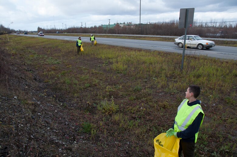 Zach Evans, son of Senior Airman Laura Evans, waits for his mom and Staff Sgt. Jeff Davidson from the 168th Wing, Alaska Air National Guard, to catch up as they worked together to pick up trash and debris along the southbound side of the Richardson Highway between Eielson AFB and Fairbanks, Alaska on September 29, 2016. The 168th’s Top III, and at least 12 other organizations that work on Eielson, are active in the Alaska Department of Transportation and Public Facilities Adopt-A-Highway program and are helping keep approximately 26 miles of the highway clean.