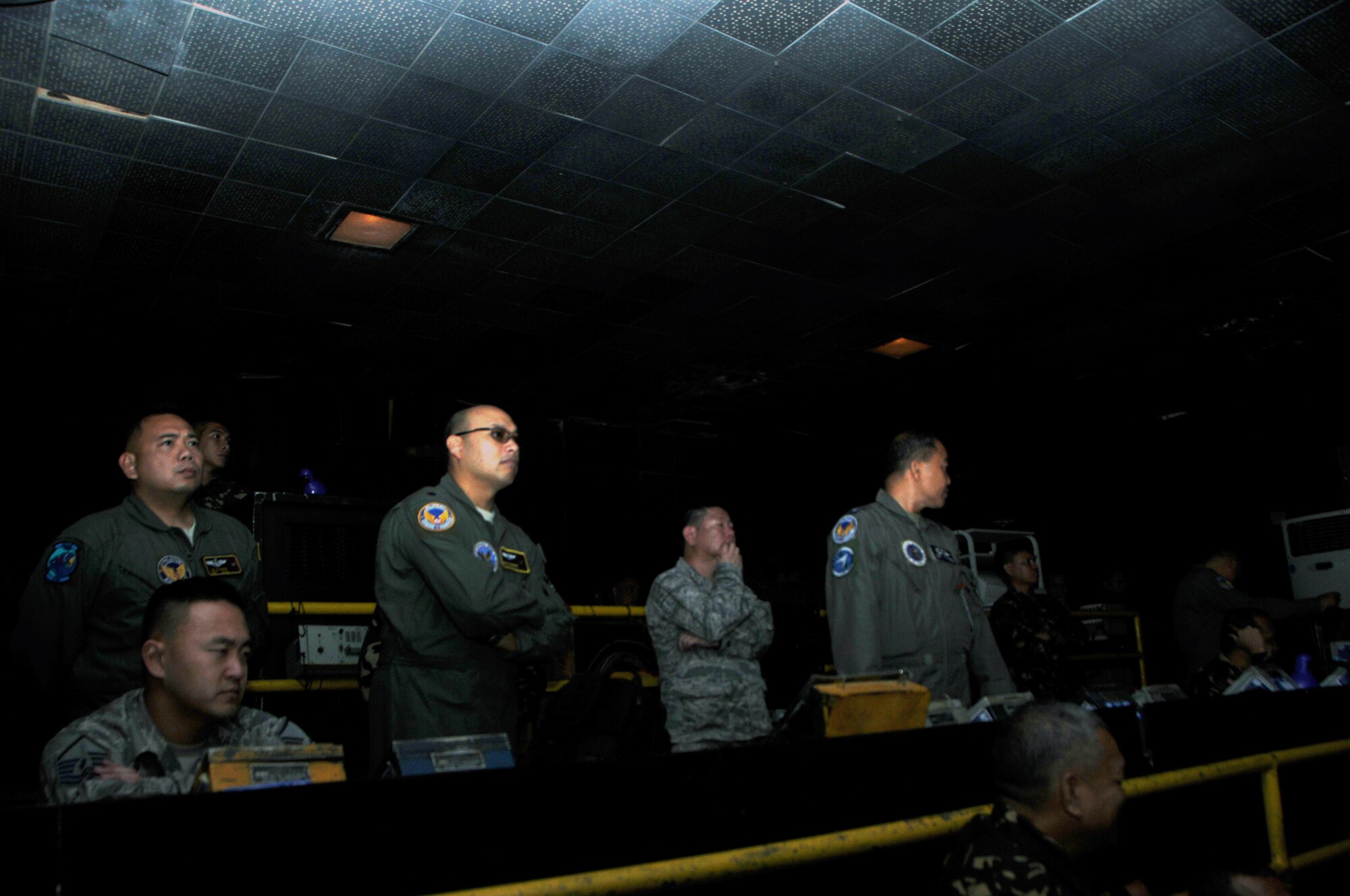 Hawaii Air National Guard Airmen observe a Philippine Air Force air intercept exercise at the control room at Wallace Air Station, Philippines, Aug. 31, 2016. The demonstration was part of a State Partnership Program subject matter expert exchange between the HIANG and PAF. The State Partnership Program is a National Guard program that links a state's national guard with a partner country to help build capacity and security cooperation. (U.S. Air National Guard photo by Senior Airman Orlando Corpuz/released) 