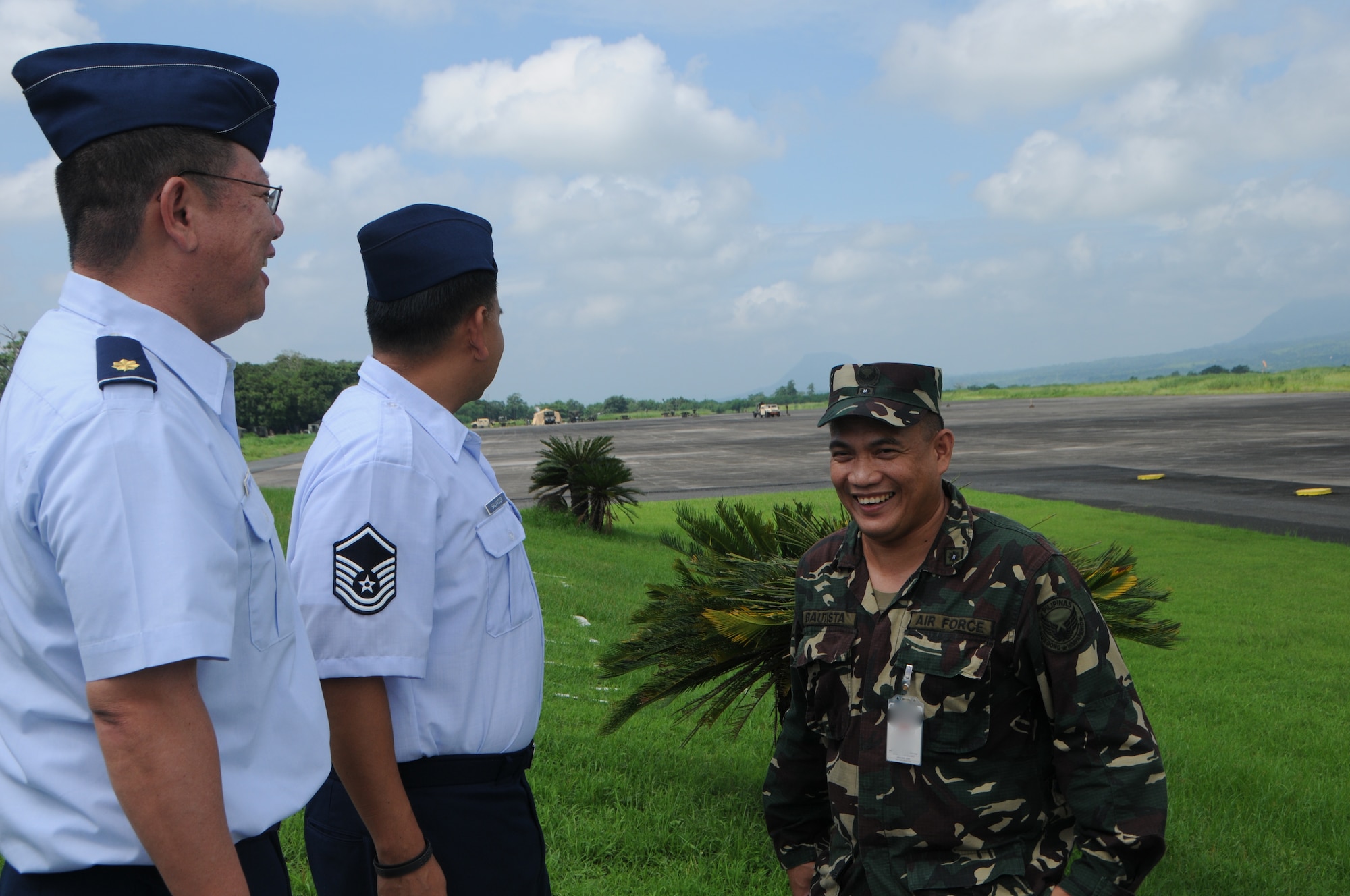U.S. Air Force Maj. Colin Yoshimitsu, mission crew commander, 169th Air Defense Squadron and Master Sgt. Joseph Salvador, loadmaster, 204th Air Lift Squadron tour the airstrip at Basa Air Base, Philippines with Philippine Air Force Maj. Generoso Bautista during a State Partnership Program subject matter expert exhange Aug. 22, 2016. The State Partnership Program is a National Guard program that links a state's national guard with a partner country to help build capacity and security cooperation. (U.S. Air National Guard photo by Senior Airman Orlando Corpuz/released) 