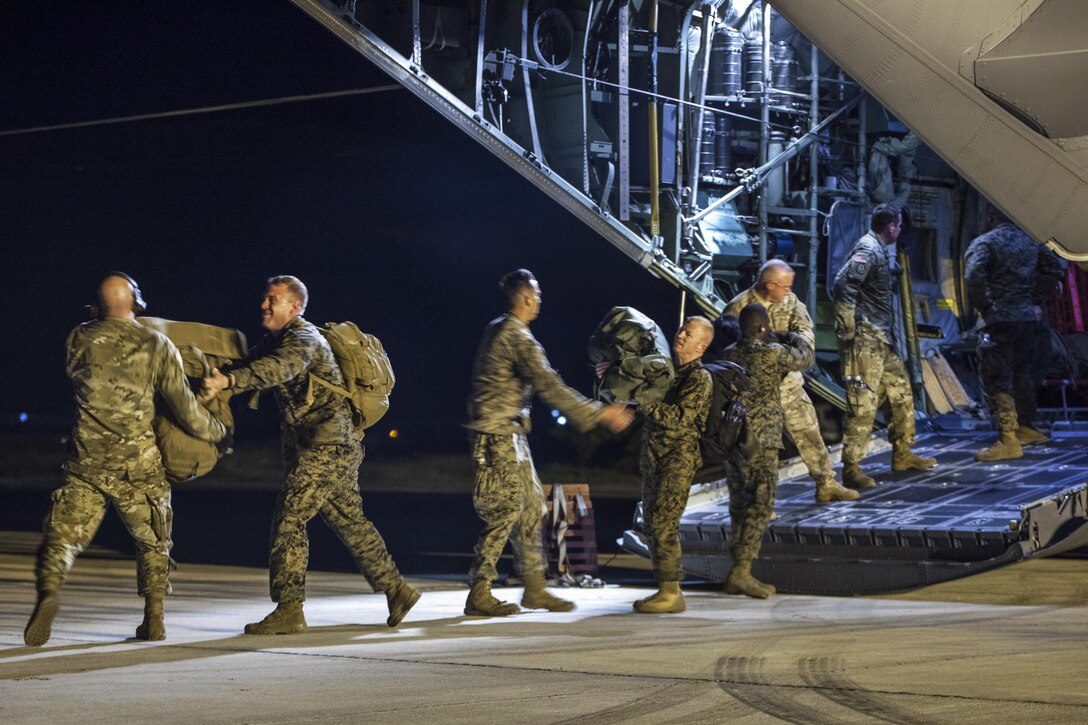 Marines and soldiers unload an Ohio Air National Guard C-130H Hercules after arriving in Port-au-Prince, Haiti, Oct. 5, 2016, to support the humanitarian assistance and disaster relief effort arising from Hurricane Matthew. The troops are part of Joint Task Force Matthew, a U.S. Southern Command-directed response team. Marine Corps photo by Sgt. Adwin Esters