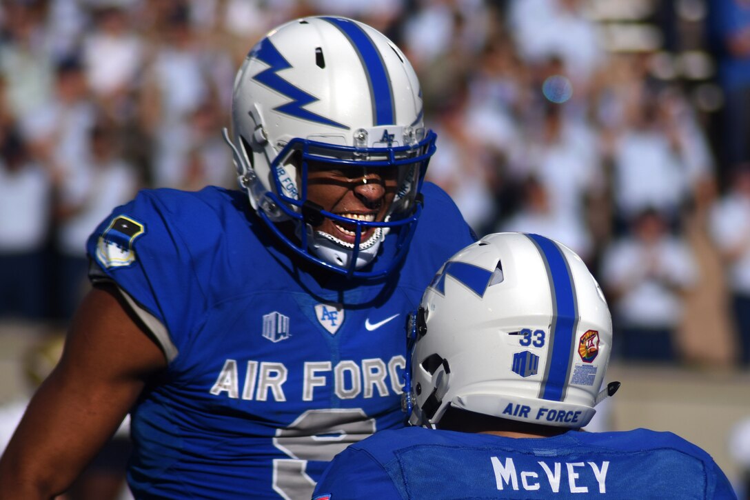 Air Force Academy Cadet 1st Class Jalen Robinette, wide receiver for the Falcons, reacts to a touchdown by Cadet 2nd Class Tim McVey, a running back, during the Air Force vs. Navy game at the academy’s Falcon Stadium in Colorado, Oct. 1, 2016. The Falcons defeated the Midshipmen 28 to 14. Air Force photo by Airman 1st Class Dennis Hoffman
