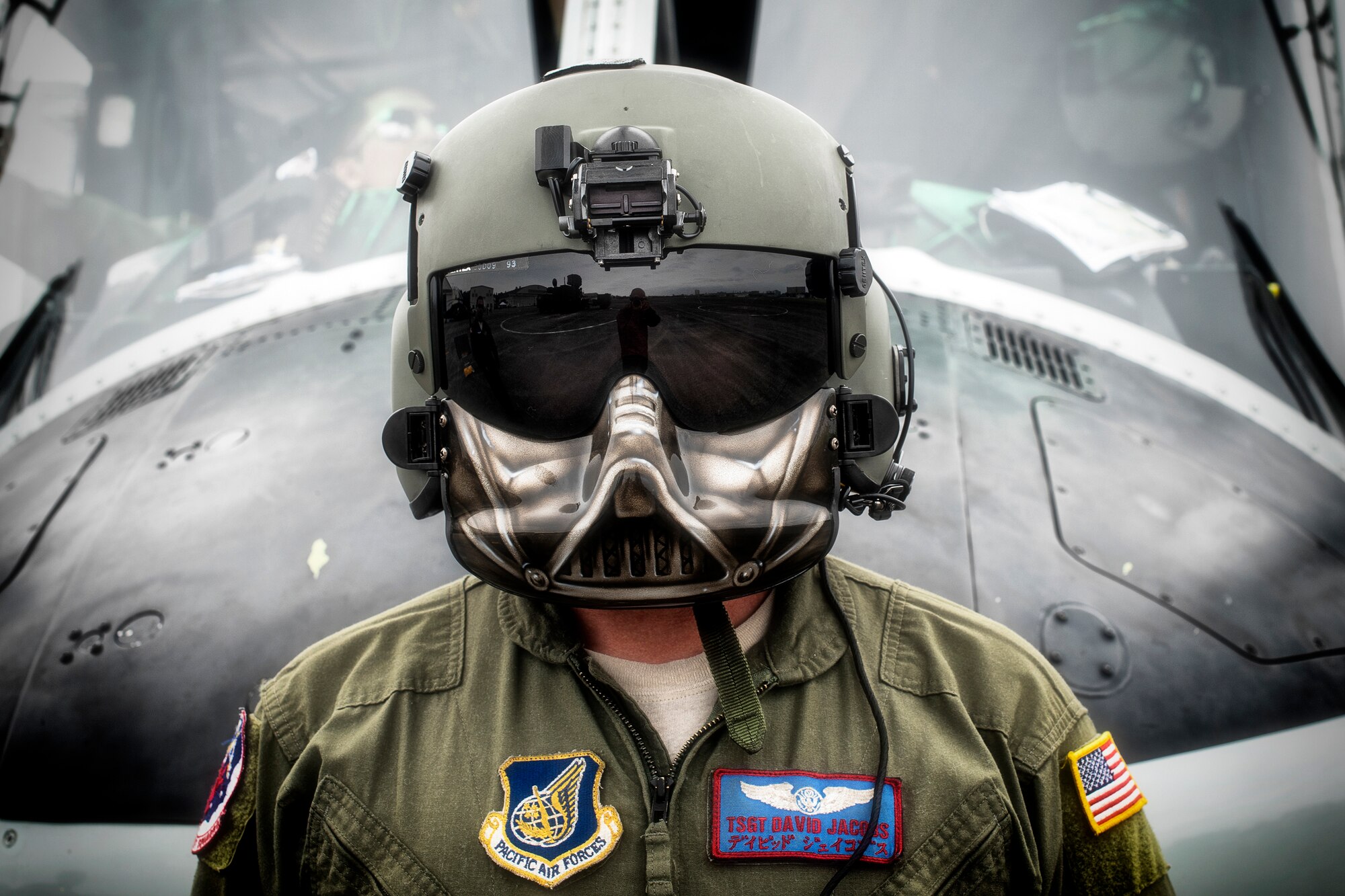 U.S. Air Force Tech. Sgt. David Jacob, 459th Airlift Squadron special mission aviator, stands in front of a UH-1N Iroquois during the 43rd Anniversary Event of Japan Ground Self-Defense Force Camp Tachikawa at JGSDF Camp Tachikawa, Japan, Oct. 1, 2016.  JGSDF UH-1Js assigned to Eastern Army Helicopter demonstrated formation flight, hoist demonstrate and disaster relief demonstration with first responders. Service members with the 459th Airlift Squadron from Yokota Air Base and Army Aviation Battalion from Camp Zama participated in the festival. (U.S. Air Force photo by Yasuo Osakabe/Released) 