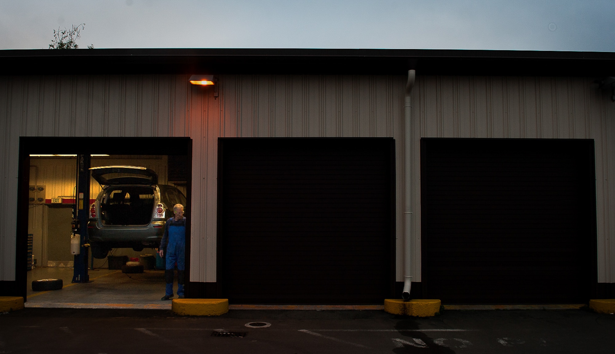 Retired Air Force Master Sgt. Greg Hermann, 86th Force Support Squadron tire technician at the Auto Hobby Shop at Ramstein Air Base, Germany, opens up his shop as he begins his work day Oct. 6, 2016. Hermann is responsible for fixing customers’ tires, and around winter time, business increases as people around the Kaiserslautern Military Community need winter tires properly tested and installed. (U.S. Air Force photo by Airman 1st Class Lane T. Plummer)