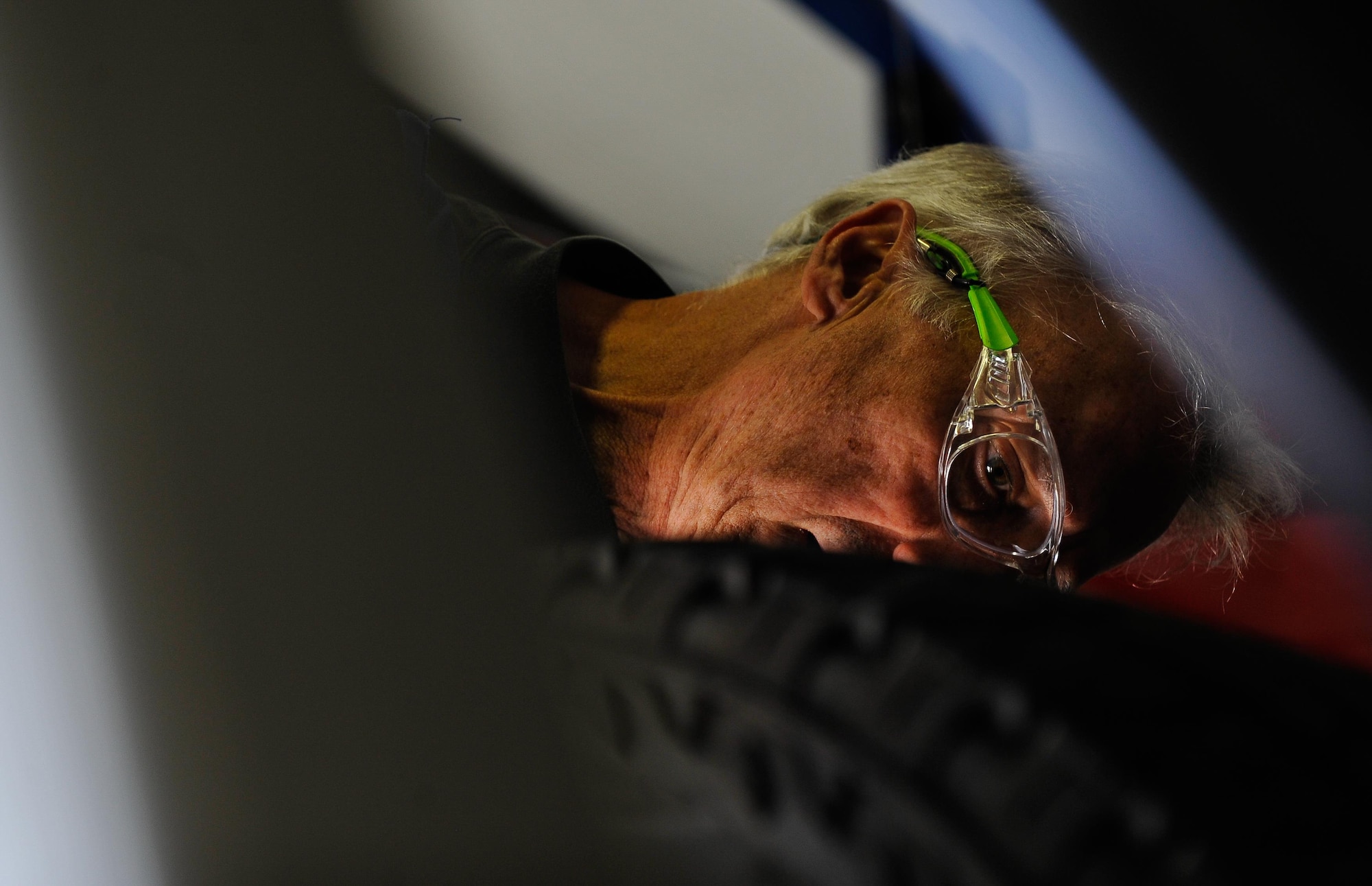 Retired Air Force Master Sgt. Greg Hermann, 86th Force Support Squadron tire technician at the Auto Hobby Shop at Ramstein Air Base, Germany, inspects a tire’s air pressure Sept. 28, 2016. Tire technicians install, repair, balance and rotate tires for passenger and commercial vehicles and ensure that tires are correctly inflated and properly replaced on the vehicle. (U.S. Air Force photo by Airman 1st Class Lane T. Plummer)