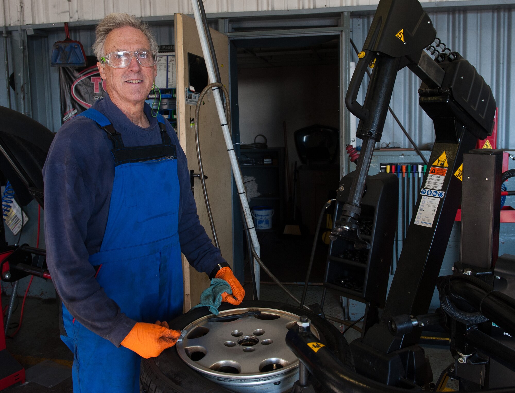 Retired Air Force Master Sgt. Greg Hermann, 86th Force Support Squadron Auto Hobby Shop tire technician, poses for a portrait at Ramstein Air Base, Germany, Oct. 5, 2016. Hermann served in the U.S. Air Force for 20 years (1972-1992) and continued to stay involved in his passion for cars after retiring. (U.S. Air Force photo by Airman 1st Class Lane T. Plummer)