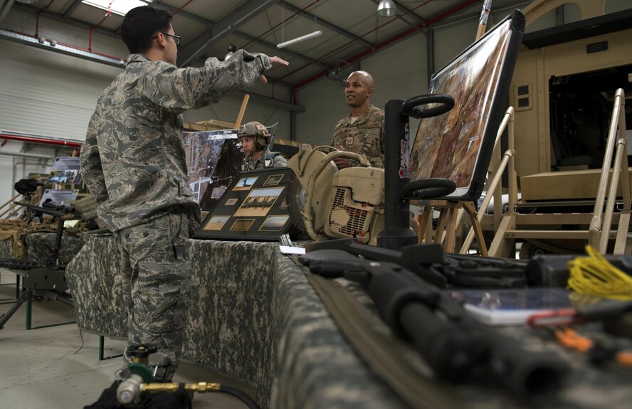 Tech. Sgt. Daniel Fox, 435th Contingency Response Support Squadron NCO in charge of Intel flight, visits the 435th Security Forces Squadron booth at the 435th Air Ground Operations Wing’s open house at Ramstein Air Base, Germany, Oct. 6, 2016.  The purpose of the open house was to highlight the 435th AGOW’s five mission areas: expeditionary airfields on demand, joint airpower integration, multi-theater operational support and sustainment, premier specialty training, and building partnership capacity. (U.S. Air Force photo by Senior Airman Tryphena Mayhugh)