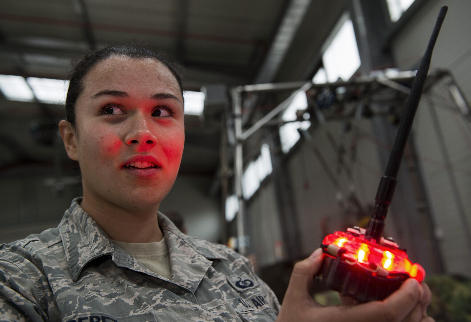 Technical Sgt. Lauren Perez, 435th Contingency Response Group contingency airfield manager, demonstrates the use of a phantom light during the 435th Air Ground Operations wing’s open house at Ramstein Air Base, Germany, Oct. 6, 2016. Phantom lights can be changed between red, white, blue and green are used to create runways in the field. (U.S. Air Force photo by Senior Airman Tryphena Mayhugh)