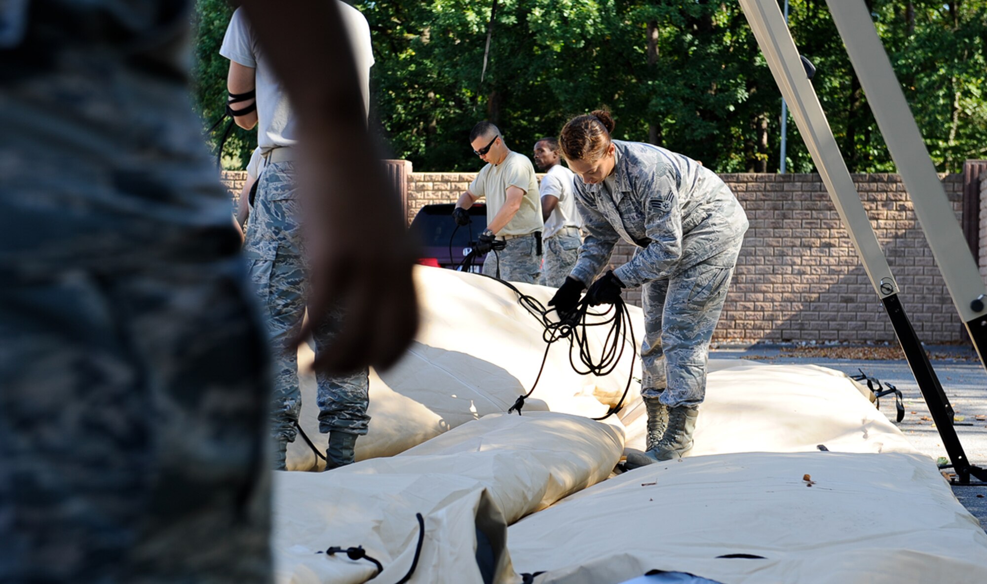 Senior Airman Jade Phrachansiri, 86th Medical Support Squadron war reserve material technician, pulls cords from a tent at Ramstein Air Base, Germany, Sept. 29, 2016. The medical logistics flight handles, cleans and assembles more than $2.3 million worth of field hospital necessities and medical equipment for exercises such as Immediate Response 2016, an exercise conducted Sept. 9 to 23. (U.S. Air Force photo by Airman 1st Class Savannah L. Waters)