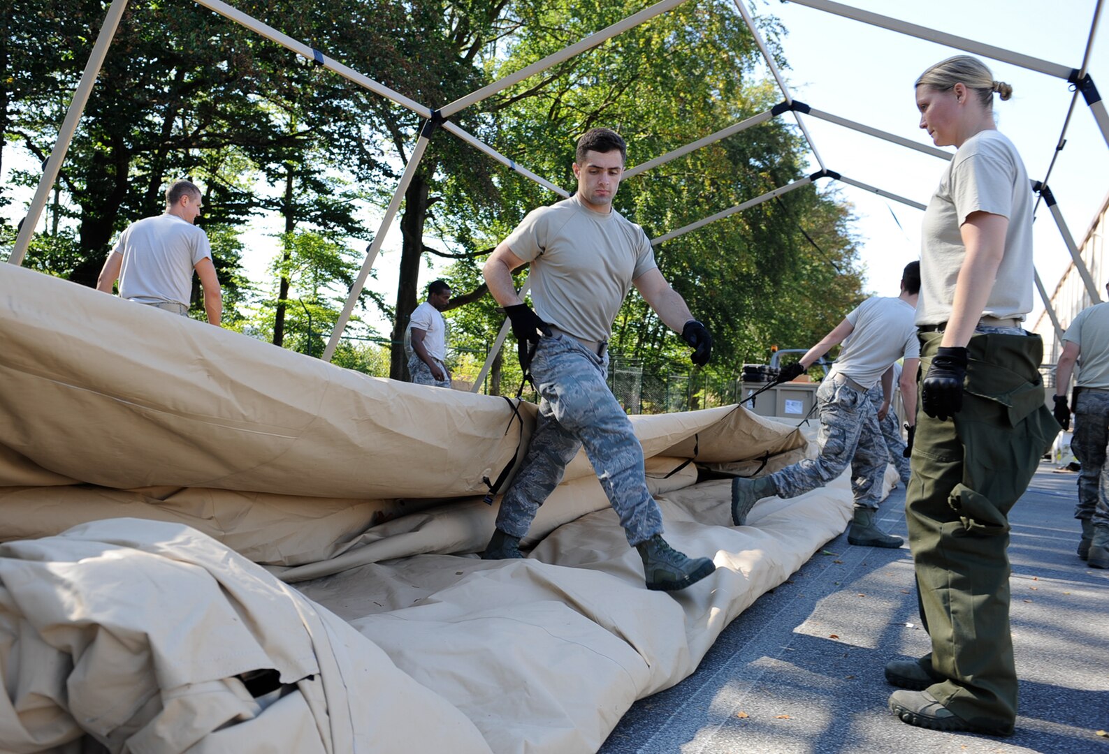 Staff Sgt. Tyler Wilson, 86th Medical Support Squadron war reserve material supervisor, helps fold a tent after it’s been cleaned out at Ramstein Air Base, Germany, Sept. 29, 2016. The Airmen have approximately 60 days after an exercise to clean and take inventory of unit type assemblages, which are packages that hold field hospital necessities such as tents and other medical equipment. (U.S. Air Force photo by Airman 1st Class Savannah L. Waters)