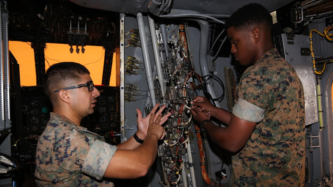 Sgt. Jesse Castillo instructs Lance Cpl. Tremain Lacy on the wiring of a CH-53 helicopter at Center for Naval Aviation Technical Training on Marine Corps Air Station New River, Oct. 3, 2016. CNATT trains Marines and Sailors in operational maintenance and repair of aeronautical equipment at the air station. Castillo is an instructor at CNATT and Lacy is a student at CNATT. 