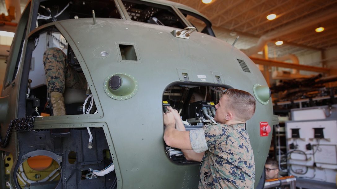 Lance Cpl. Jeffrey McCarn connects cables to the front of a CH-53 helicopter at the Center for Naval Aviation Technical Training on Marine Corps Air Station New River, Oct. 3, 2016. CNATT trains Marines and Sailors in operational maintenance and repair of aeronautical equipment at the air station. McCarn is a student at CNATT. 