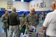 Chief Master Sgt. John Bentivegna, 50th Space Wing command chief, gathers information packets while an organization representative speaks with other Airmen during the 2016 Combined Federal Campaign kick-off event at Schriever Air Force Base, Colorado, Tuesday, Oct. 4, 2016. Forty organizations provided information to Team Schriever members. (U.S. Air Force photo/Christopher DeWitt)