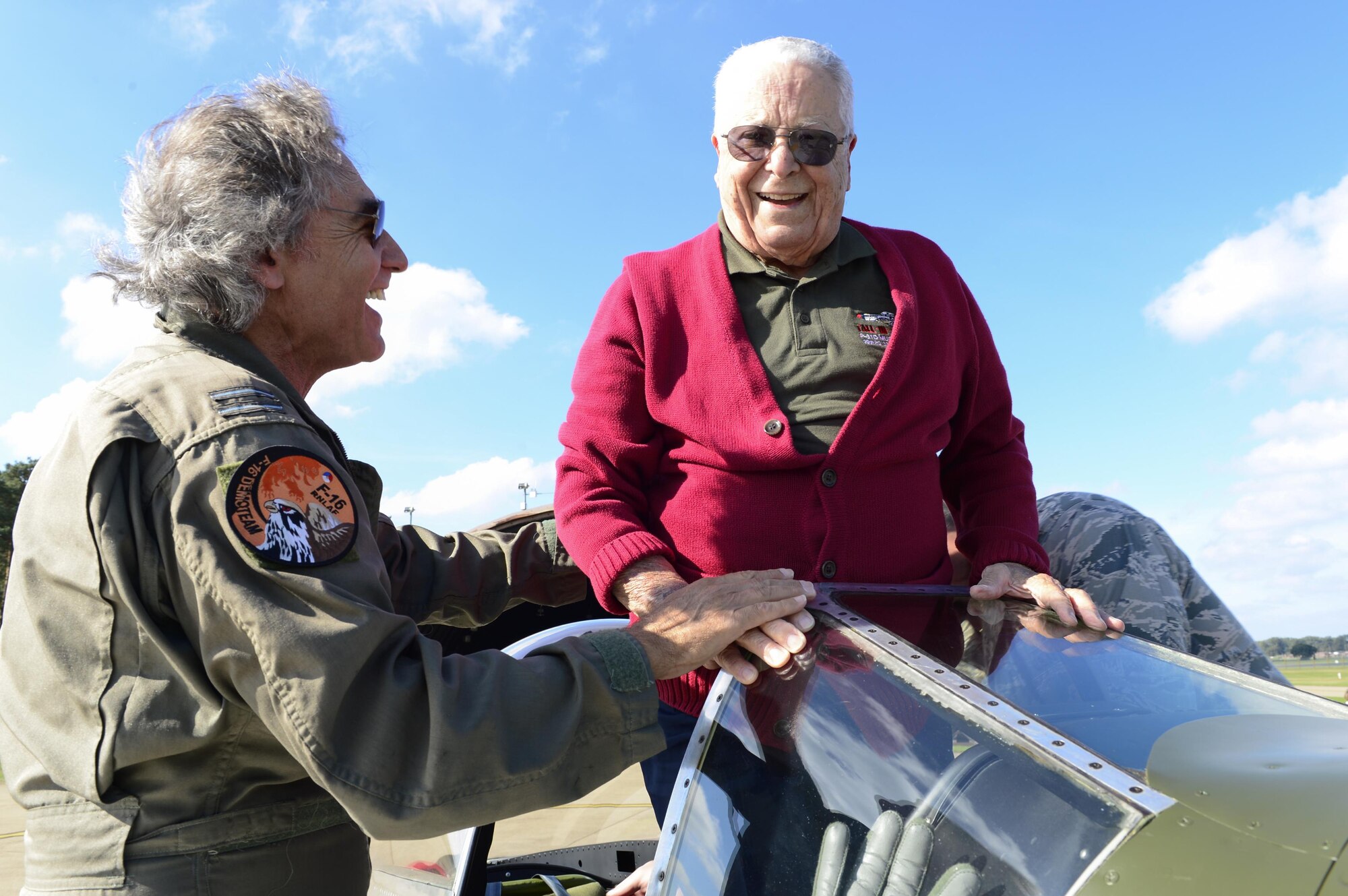 Peter Teichman, left, Hangar 11 Collection pilot, and retired Tuskegee Airman U.S. Air Force Lt. Col. George E. Hardy, stand on top of Hardy’s former P-51D Mustang at Royal Air Force Lakenheath, England, Oct. 4, 2016. Hardy, among 354 other Tuskegee Airmen, were sent overseas during World War II to fly and maintain combat aircraft. (U.S. Air Force photo/ Senior Airman Malcolm Mayfield)