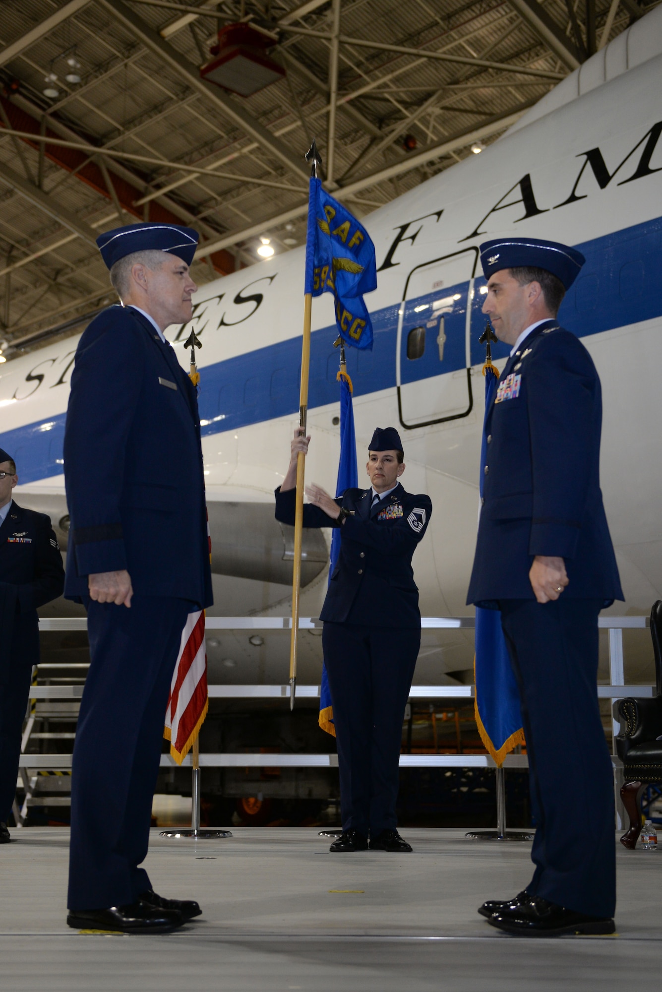 U.S. Col Robert Billings, right, prepares to accept the 595th Command and Control Group flag from Maj. Gen. Thomas Bussiere, Eighth Air Force commander, left, signifying his acceptance to command the group. The 595th CACG was activated during the E-4B realignment ceremony at Offutt Air Force Base, Neb., Oct. 7, as part of an initiative to house all Air Force nuclear assets under Air Force Global Strike Command. (U.S. Air Force photo by )