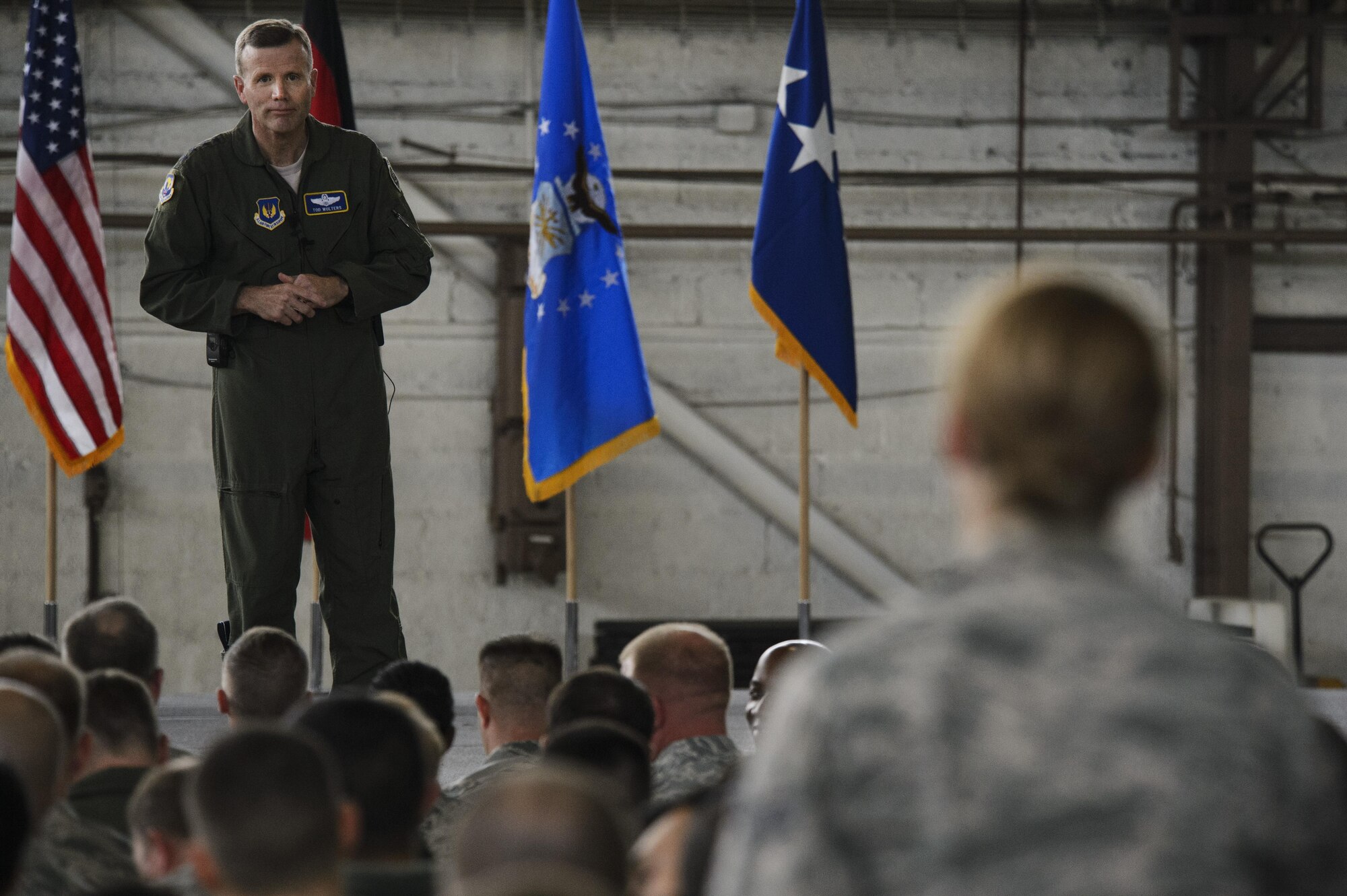 Gen. Tod D. Wolters, U.S. Air Forces in Europe and Air Forces Africa commander, listens to a question from Senior Airman Kimberly Deveau, 52nd Medical Operations Squadron medical technician, during a question and answer portion of an all call at Hangar One on Spangdahlem Air Base, Germany, Oct. 6, 2016. This visit represented his first time at Spangdahlem Air Base since assuming command in August 2016. (U.S. Air Force photo by Staff Sgt. Jonathan Snyder)