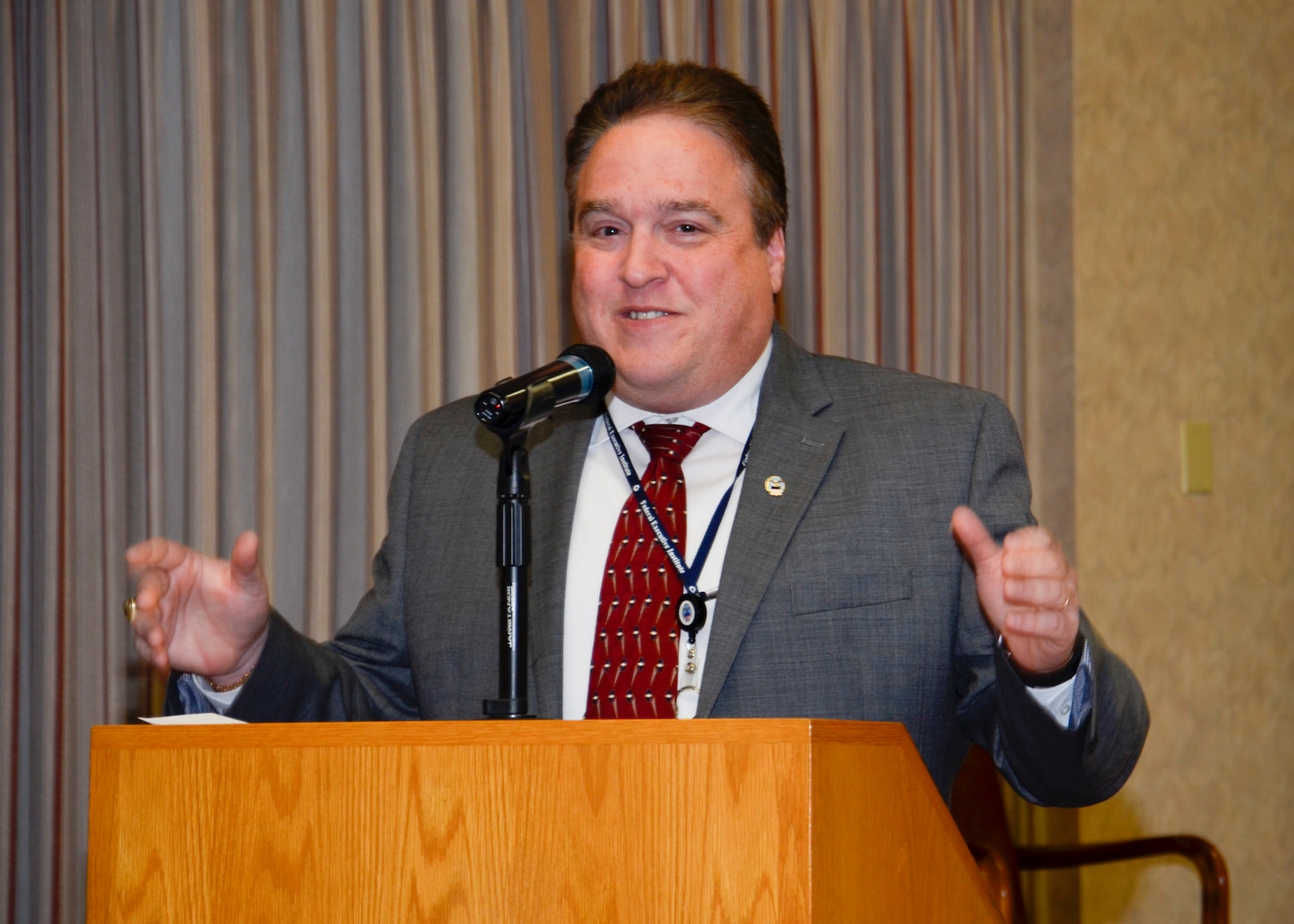 Ray Zingaretti, Logistics Information Services director, addresses the audience during his closing remarks at the Hart-Dole-Inouye Federal Center's People With Disabilities program. 