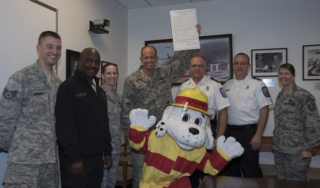 The 11th Wing leadership and 11th Civil Engineering fire department leadership pose for a photo with the signed 2016 Fire Prevention Week proclamation at Joint Base Andrews, Md., Oct. 7, 2016. Fire Prevention Week will be recognized at JBA Oct. 9 to Oct. 15. (U.S. Air Force photo by Airman 1st Class Rustie Kramer)
