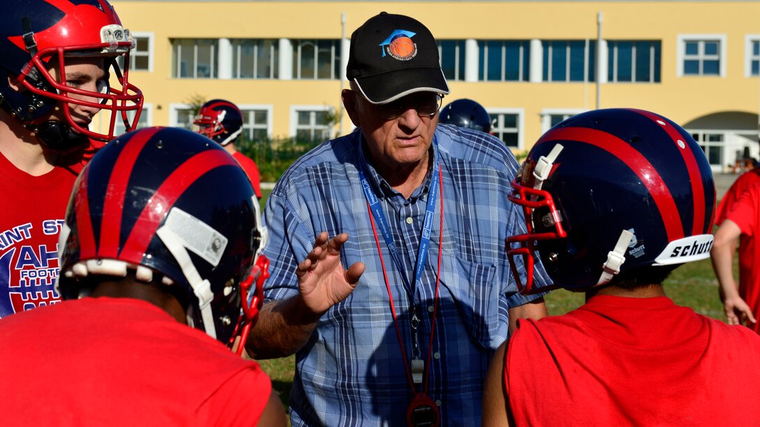 Coach Ken McNeely gives advice to Aviano Saints football players during a practice at Aviano Air Base, Italy on Oct. 1, 2016. Coach McNeely was the original head coach when the team started in 1974. (U.S. Air Force photo by Airman 1st Class Cary Smith/Released)
