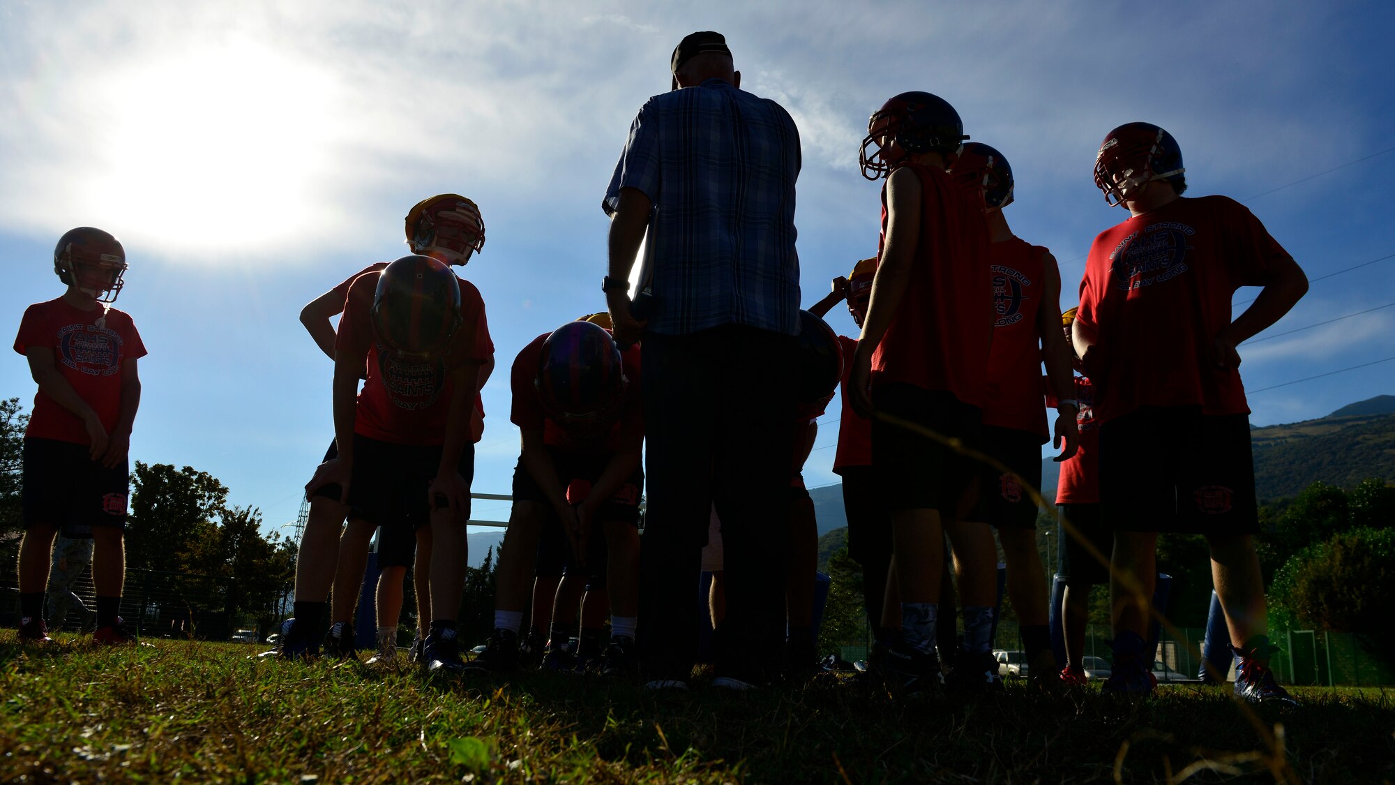 Coach Ken McNeely gives advice to Aviano Saints football players during a practice at Aviano Air Base, Italy on Oct. 1, 2016. The coaches use football to provide Aviano youths life lessons. (U.S. Air Force photo by Airman 1st Class Cary Smith/Released)