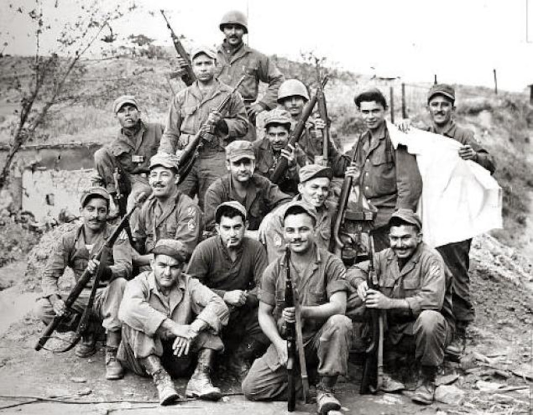 Members of the 65th Infantry Regiment pose for a photo after a firefight during the Korean War. The regiment consisted primarily of Puerto Rican soldiers who spoke mainly Spanish and prided themselves on having mustaches. By 1953, the regiment’s soldiers had earned 14 Silver Stars, 23 Bronze Stars for valor and 67 Purple Hearts. Courtesy photo
