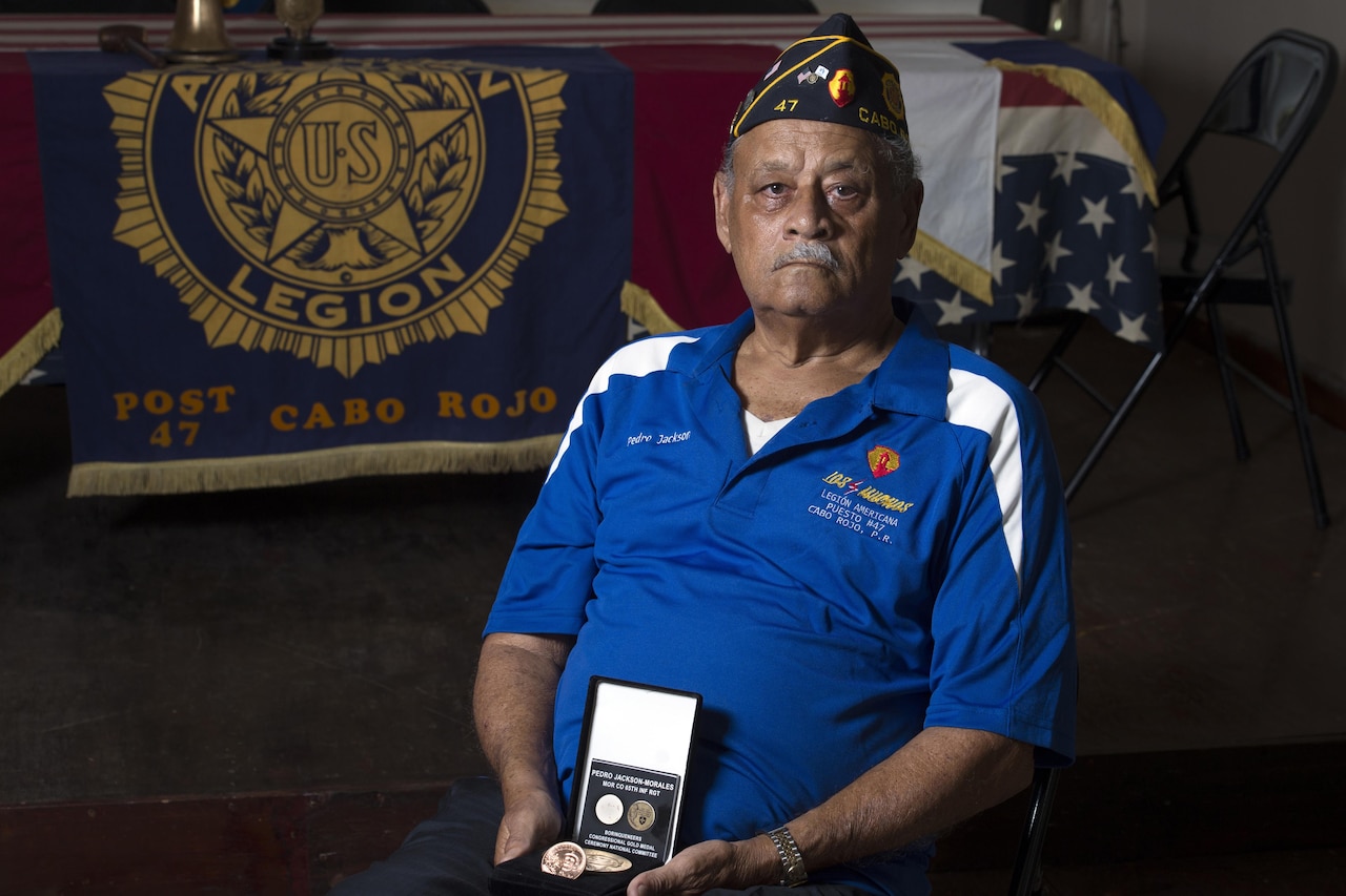 Korean War veteran Army Pfc. Pedro Jackson-Morales holds a Congressional Gold Medal in Cabo Rojo, Puerto Rico, Aug. 10, 2016. DoD photo by EJ Hersom