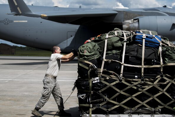 Staff Sgt. Brennon Scott, a 23rd Logistics Readiness Squadron air terminal operations supervisor, secures luggage and weapons on a pallet for a deployment Sept. 26, 2016, at Moody Air Force Base, Ga. The pallet was loaded onto a C-17 Globemaster III for transport. (U.S. Air Force photo/Airman 1st Class Daniel Snider)