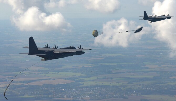 Two U.S. Air Force MC-130J Commando IIs perform Maritime Craft Aerial Delivery System drops over the Little Belt strait in Denmark Sept. 27, 2016. After rigid inflatable boats were deployed, U.S. Navy Special Warfare Combatant Craft crewmen followed to set up the equipment. Finally, a third aircraft off-loaded U.S. Air Force and Danish airmen at the drop zone. (U.S. Air Force photo/Senior Airman Justine Rho)