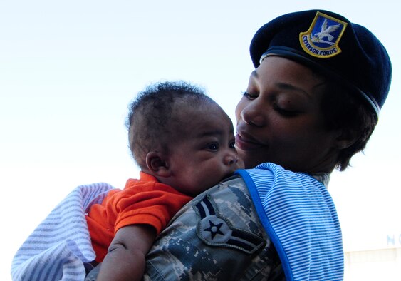 Airman 1st Class Erica Thompson, of the 145th Security Forces Squadron, holds her son, Napoleon, during a family day event at Charlotte Douglas International Airport, N.C., Oct. 1, 2016. Family day gave North Carolina Air National Guard Airmen the opportunity to show their families what happens during a regularly scheduled drill weekend. (U.S. Air National Guard photo/Staff. Sgt. Julianne M. Showalter)

