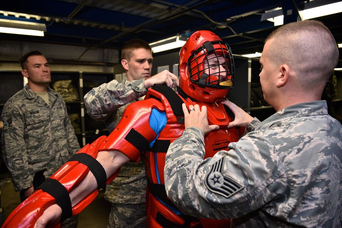 932nd Airlift Wing commander, Col. Jonathan Philebaum, suits up in the Security Forces's RedMan suit, to play the role of the aggressor, during baton training at Scott Air Force Base, Illinois, Oct. 1, 2016.  The suit is designed so that baton trainees are able strike without causing injury. After wearing the suit for several rounds of training, Philebaum had this to say, "I'm glad that I'm on the  932nd Security Forces defender team, they all know what they are doing and get the job done right the first time."  (U.S. Air Force photo by Tech. Sgt. Christopher Parr)