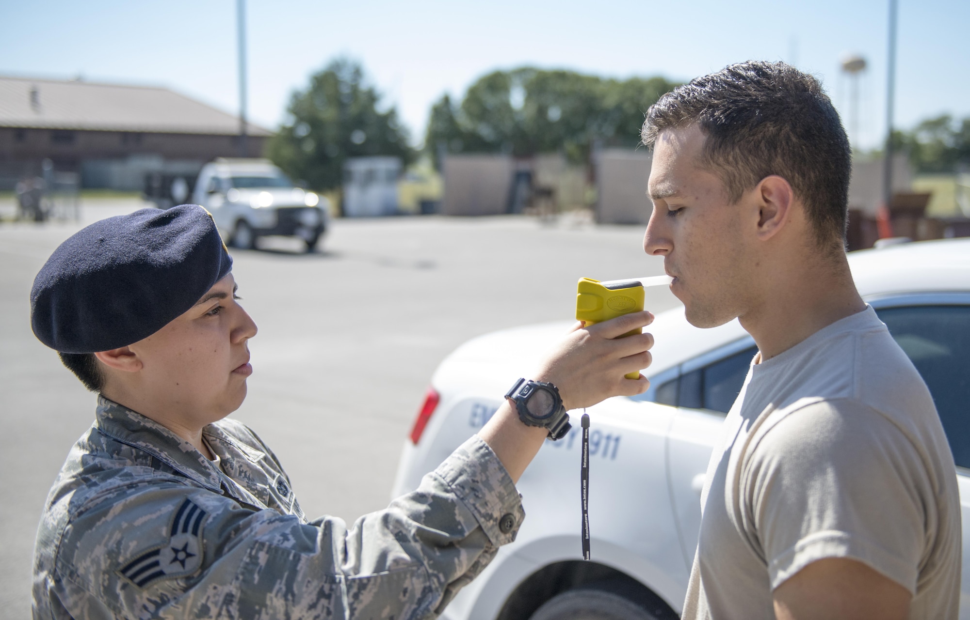U.S. Air Force Senior Airman Rylynn Paz, the 509th Security Forces Squadron (SFS) assistant NCO in charge of police services and corrections, left, demonstrates the proper use of a portable breathalyzer test (PBT) with Airman 1st Class John Cabral, 509th SFS member, at Whiteman Air Force Base, Mo.,  Sept. 30, 2016. PBTs, used by SFS to check drivers’ blood alcohol content, are one of several tools used by SFS members to determine if drivers have been driving under the influence of alcohol. (U.S. Air Force photo by 1st Lt. Matthew Van Wagenen)