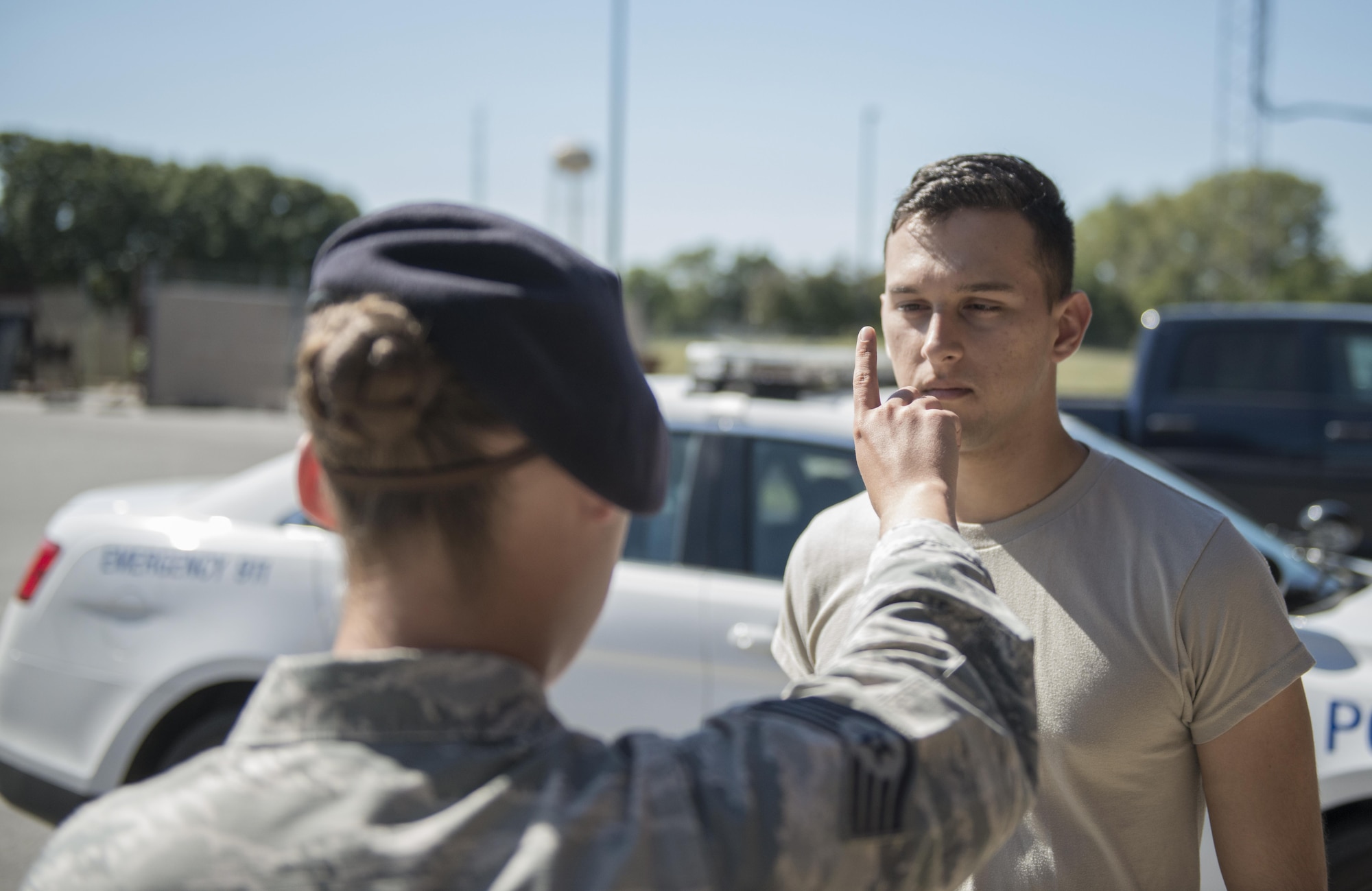 U.S. Air Force Staff Sgt. Devin Pope, 509th Security Forces Squadron (SFS) training instructor, left, demonstrates the Horizontal Gaze Nystagmus (HGN) test with Airman 1st Class John Cabral, 509th SFS member, at Whiteman Air Force Base, Mo., Sept. 30, 2016. As part of Standard Field Sobriety Test used by SFS when a driver is suspected of driving under the influence of alcohol or drugs, patrolmen carry out HGN tests during which they check a driver’s eyes for indications of impairment. (U.S. Air Force photo by 1st Lt. Matthew Van Wagenen)